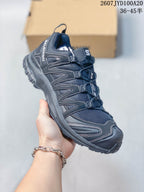 Angled side view of the black trail running shoe with mesh panels, overlays and reinforced toe area.