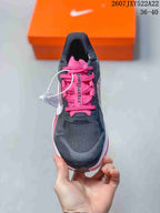 Top view showing the black toe area, pink tongue, and pink laces.