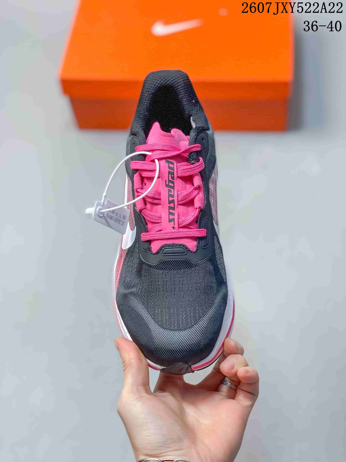 Top view showing the black toe area, pink tongue, and pink laces.