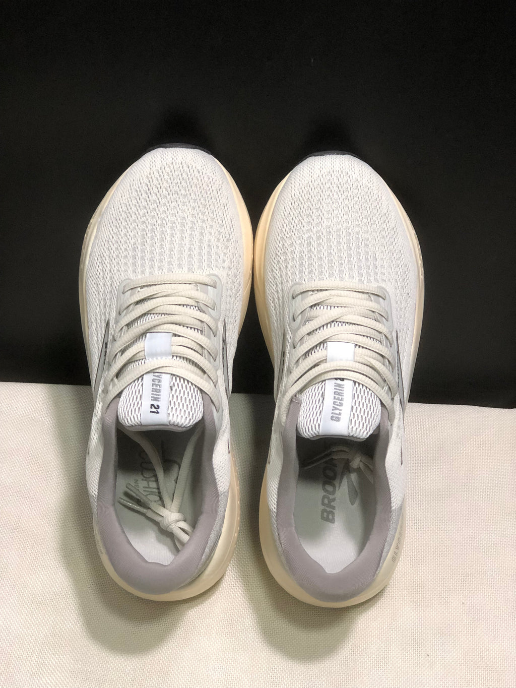 Top-down view showing the white mesh-style uppers, laces, padded collars, and tongue branding.