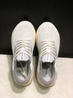 Top-down view showing the white mesh-style uppers, laces, padded collars, and tongue branding.