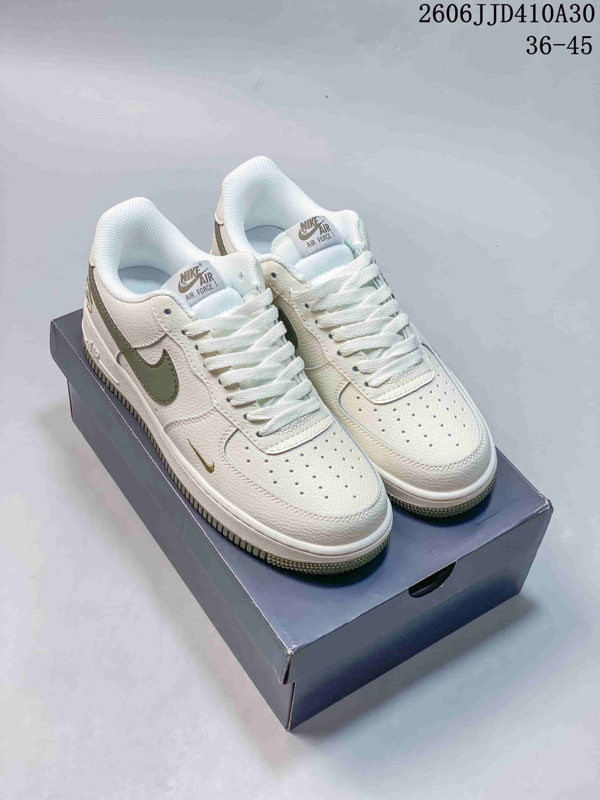 Pair of white Nike Air Force 1 '07 Low sneakers with olive-colored Swoosh accents
