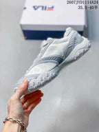 Side view showing the layered upper panels, mesh-like sections, and textured outsole.