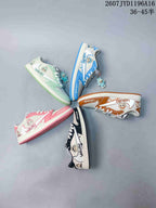 Five color options of the low-top sneakers arranged together, including blue, mint, brown, pink and black.
