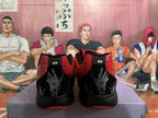 Rear view of red and black Nike basketball shoes with embroidered heel details