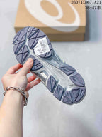 Bottom view of the sneaker showing the patterned outsole and a visible size sticker marked 39.