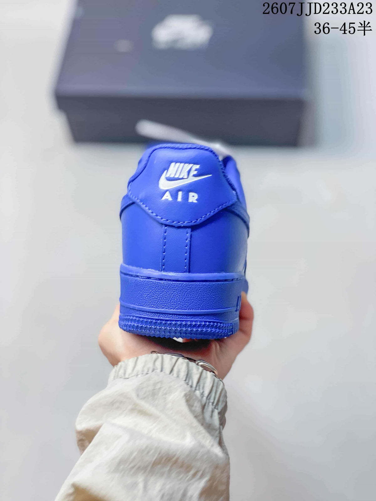 Rear view of the blue sneaker showing Nike Air branding on the heel.