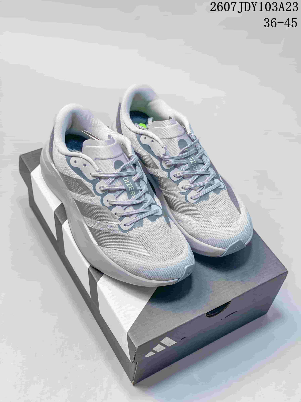 Pair of light gray and white adidas Adizero Evo SL M running shoes displayed on a shoebox, with the listed size range visible at the top.