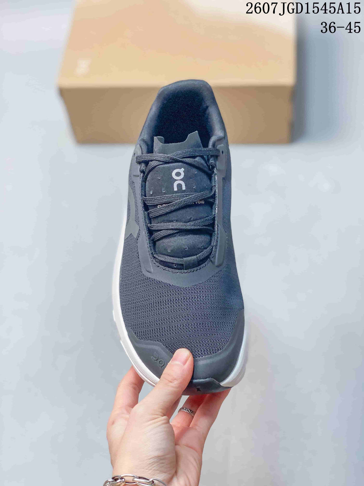 Top view showing the dark gray woven-texture toe, laces, tongue, and padded collar.