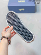 Close view of the sneaker outsole showing a white rubber edge and dark waffle-pattern tread.