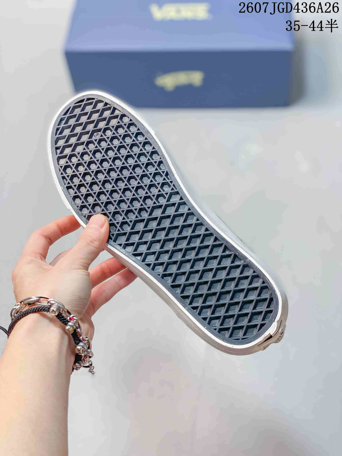 Close view of the sneaker outsole showing a white rubber edge and dark waffle-pattern tread.