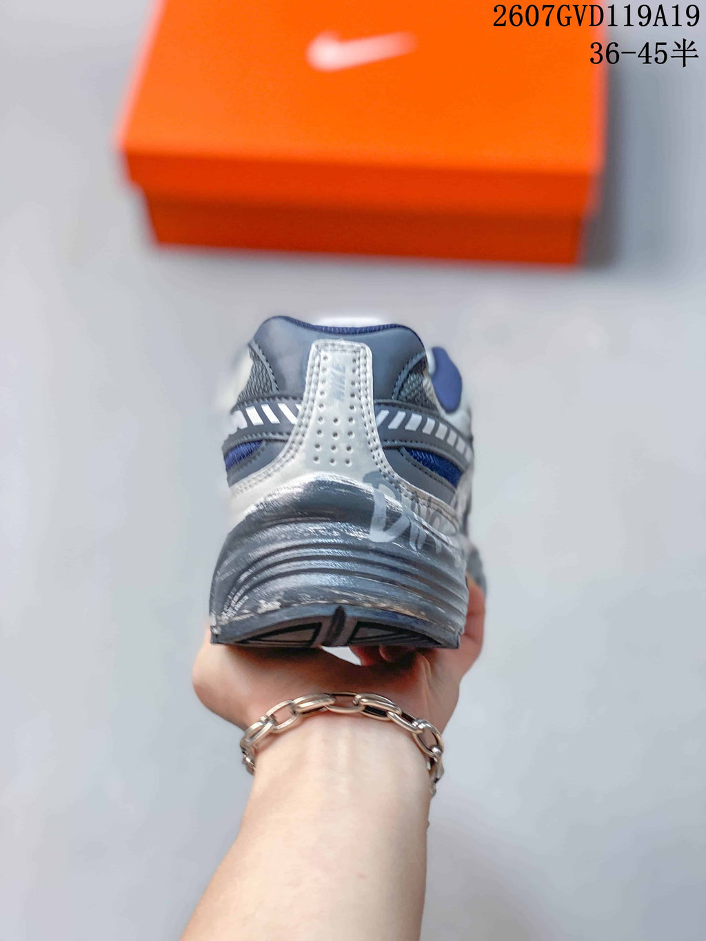 Rear view showing the layered heel construction and dark outsole of the sneaker.
