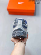 Rear view showing the layered heel construction and dark outsole of the sneaker.