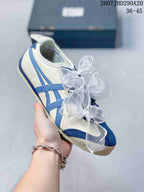 Side view of a white sneaker with blue stripes, blue toe detailing, and translucent ribbon laces.