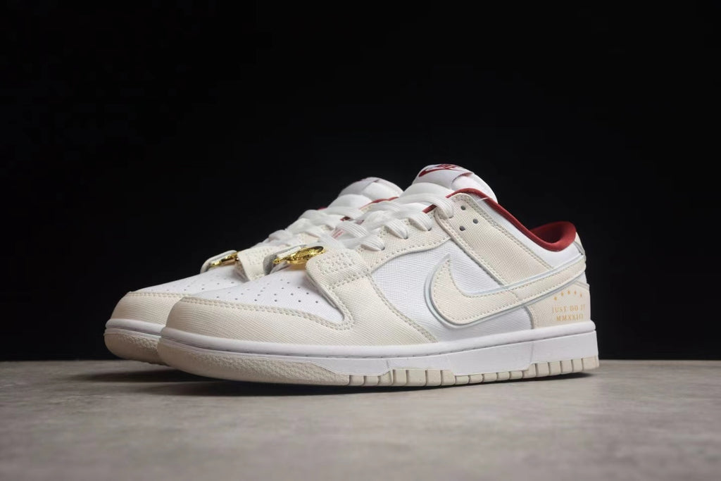 Three-quarter side view of the pair showing the layered upper, gold-tone clasp, and printed heel detail.