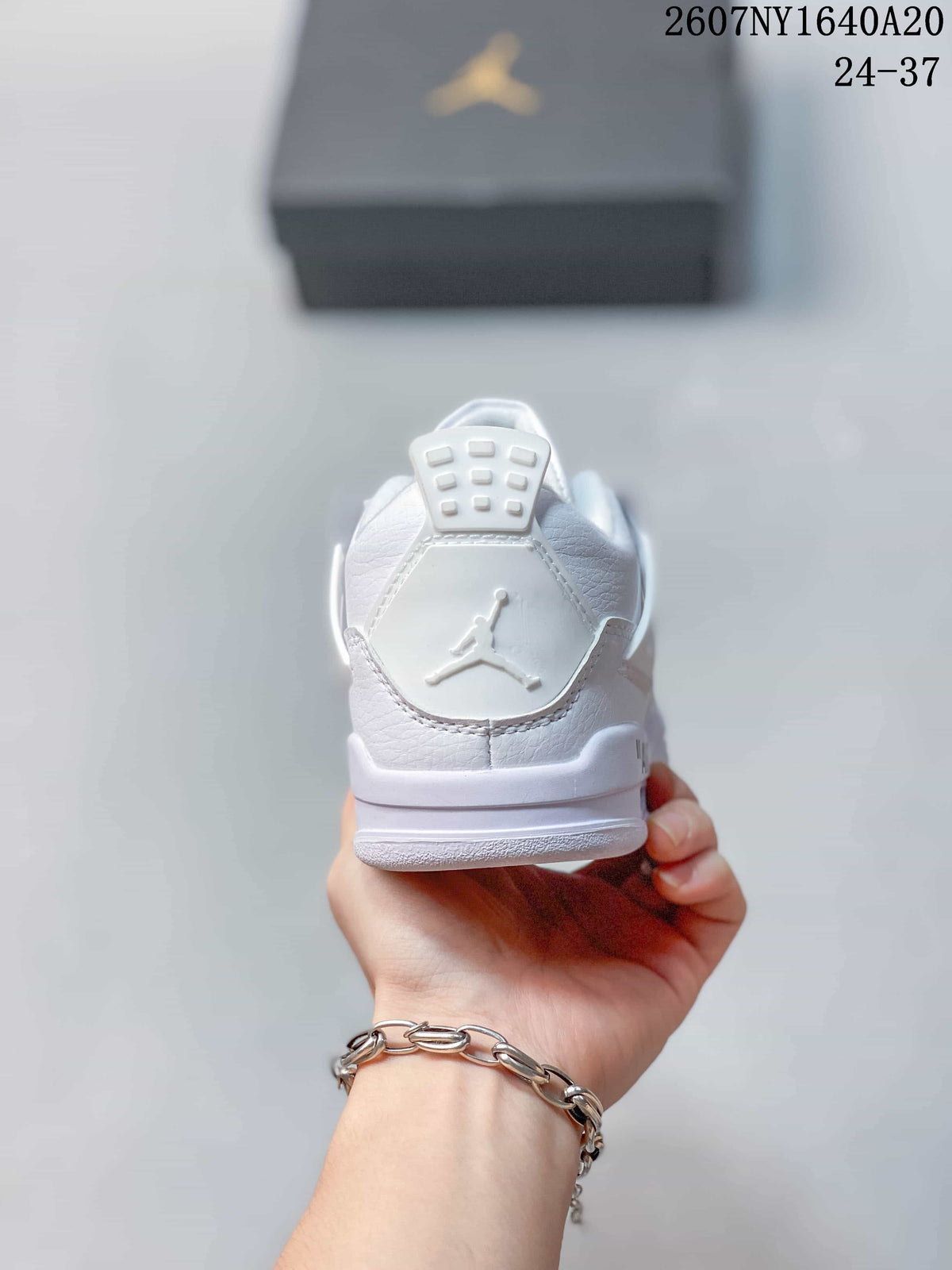 Rear view showing the padded heel, Jumpman logo, and layered white midsole.