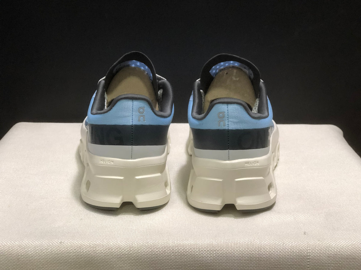 Rear view of the pair showing the padded collars, dark heel details, and white sculpted midsoles.