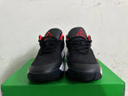 Front view of black basketball shoes with red tongue logos and red lining.