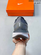 Rear view of the gray Nike sneaker showing the padded heel structure and layered midsole.