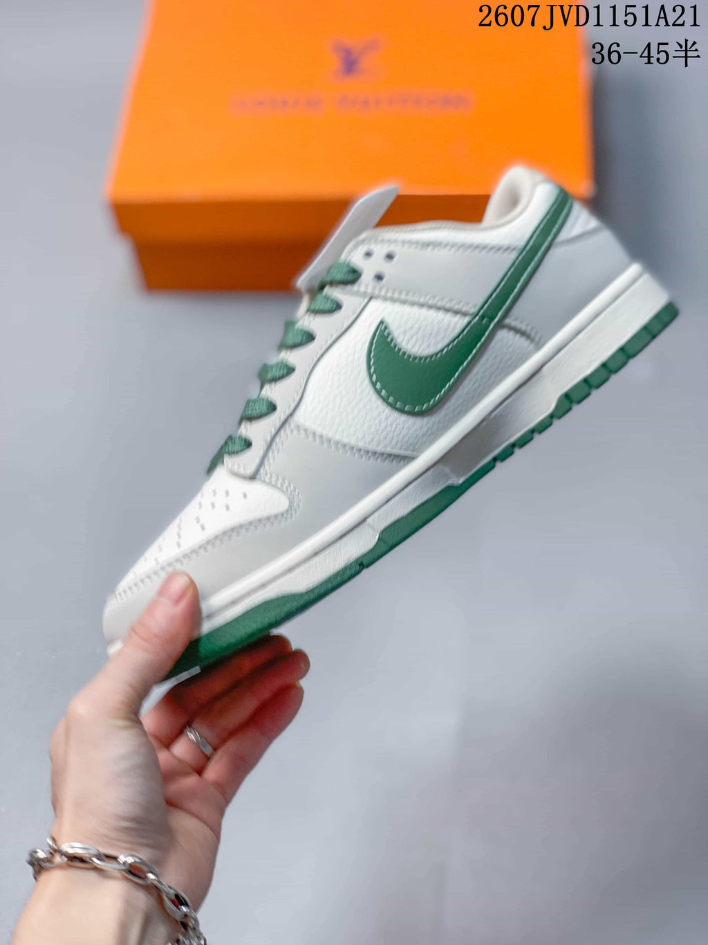 Side profile of the white and green low-top sneaker showing the green Swoosh, layered panels, and outsole.