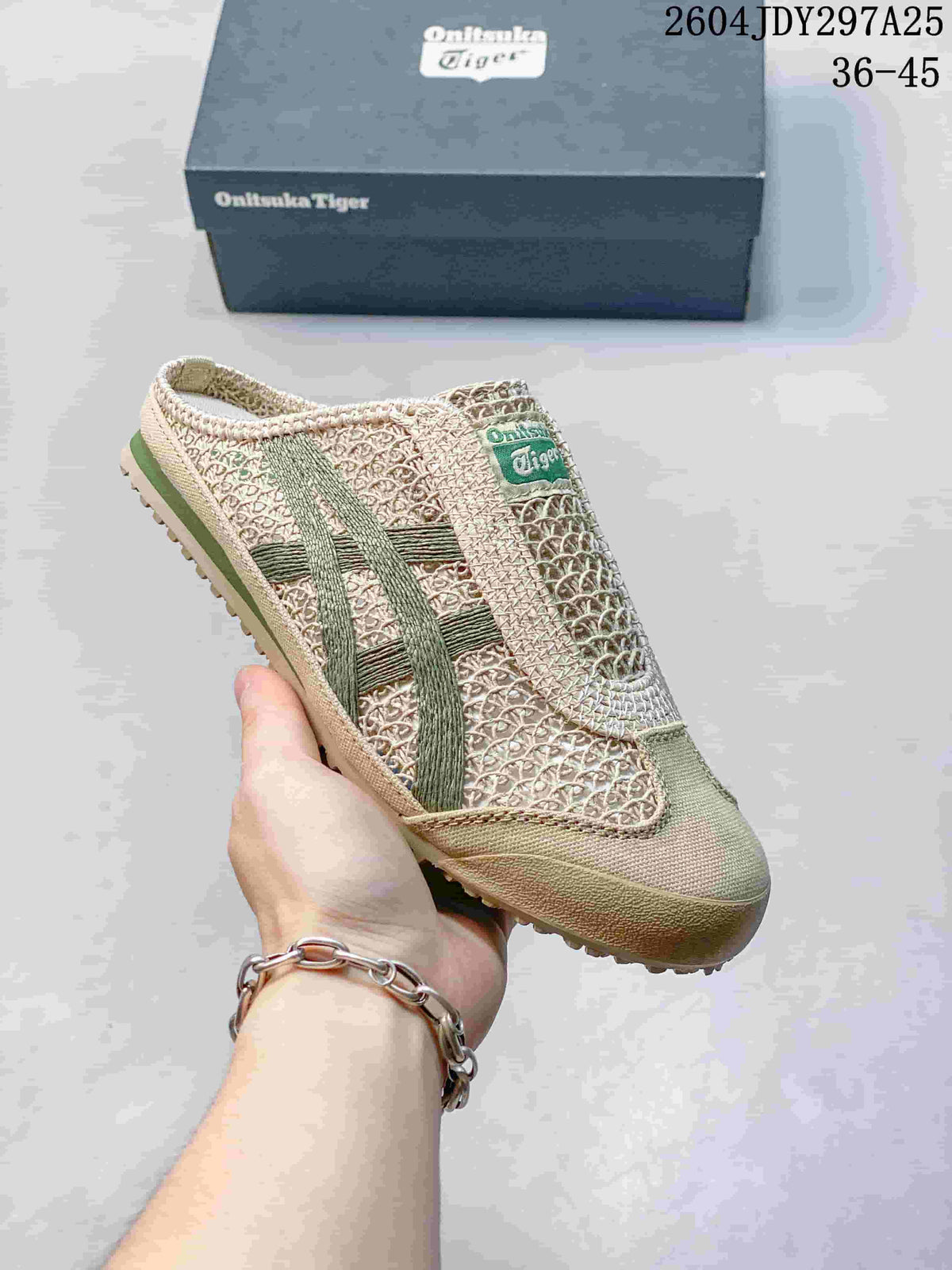 Angled side view of the beige and green Onitsuka Tiger Mexico 66 Sabot sneaker with its shoe box in the background.