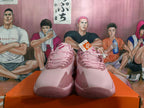 Front view of pink Nike basketball shoes with lace-up fastening.