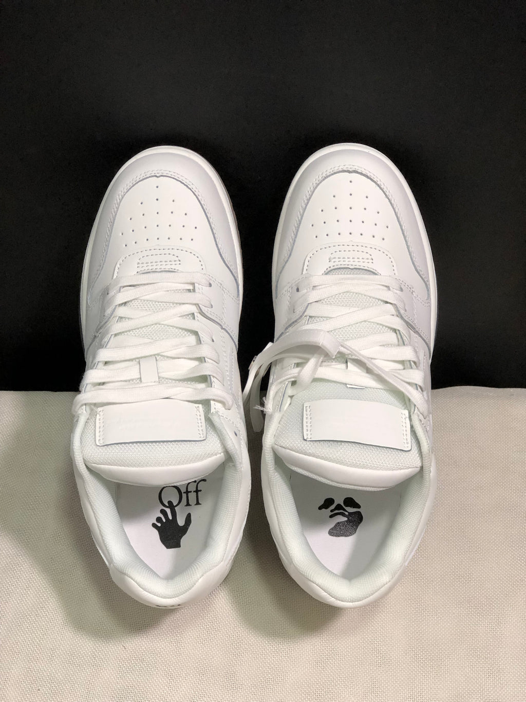 Top view showing white laces, perforated toe boxes, padded tongues and branded footbeds.