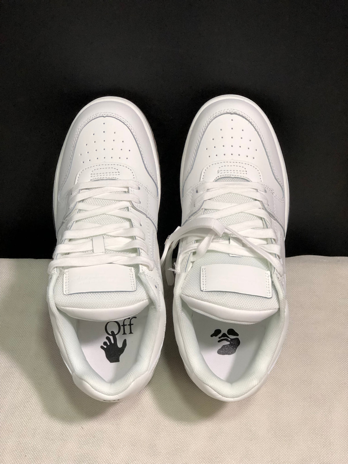 Top view showing white laces, perforated toe boxes, padded tongues and branded footbeds.