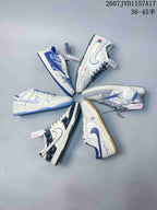 Overhead arrangement showing several different low-top sneaker colorways, including blue denim-inspired, white and blue, gray, navy, and gum-outsole designs.