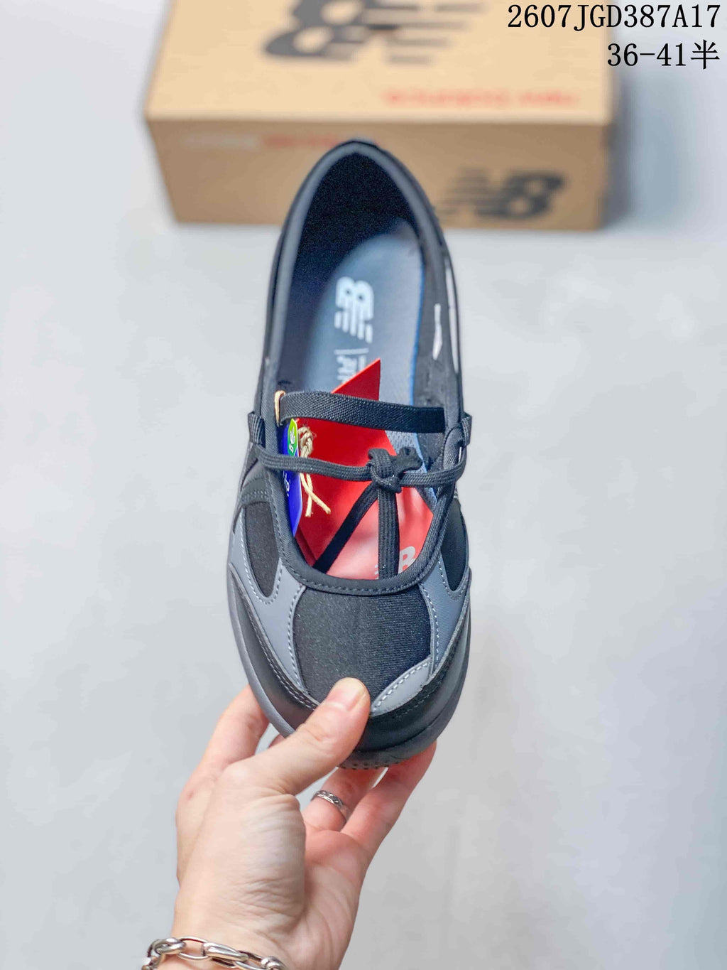 Top view showing the rounded toe, black and gray panels, laces, and cross-foot strap detail.
