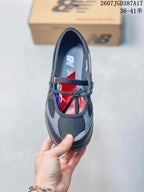 Top view showing the rounded toe, black and gray panels, laces, and cross-foot strap detail.