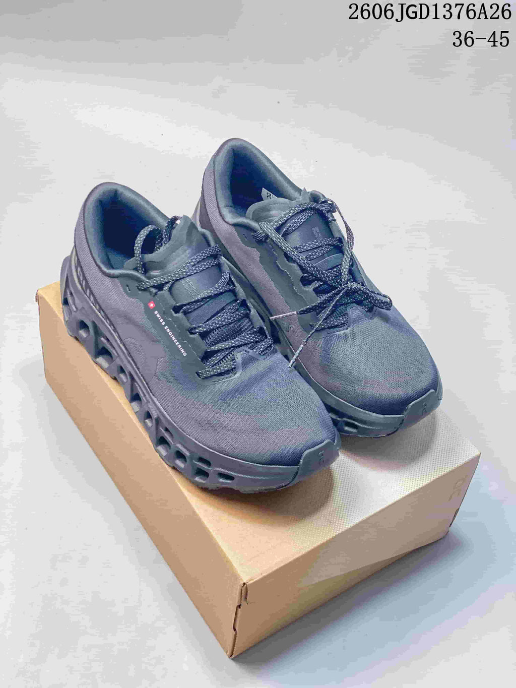 Pair of dark blue-gray On Cloudmonster 3 shoes with cutout-style soles