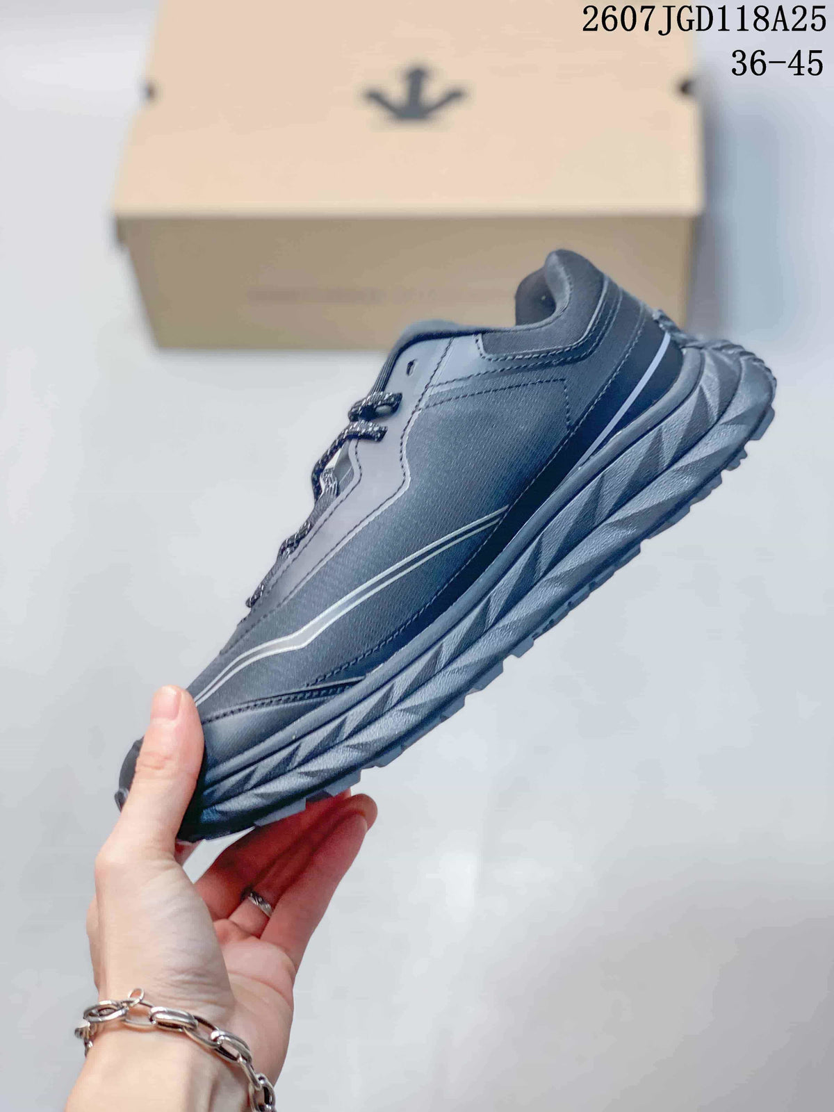 Side profile of the dark gray low-top hiking shoe with layered sole construction and contrasting linear accents.