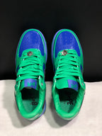 Top-down view showing green laces, blue perforated toe panels and padded green collars.