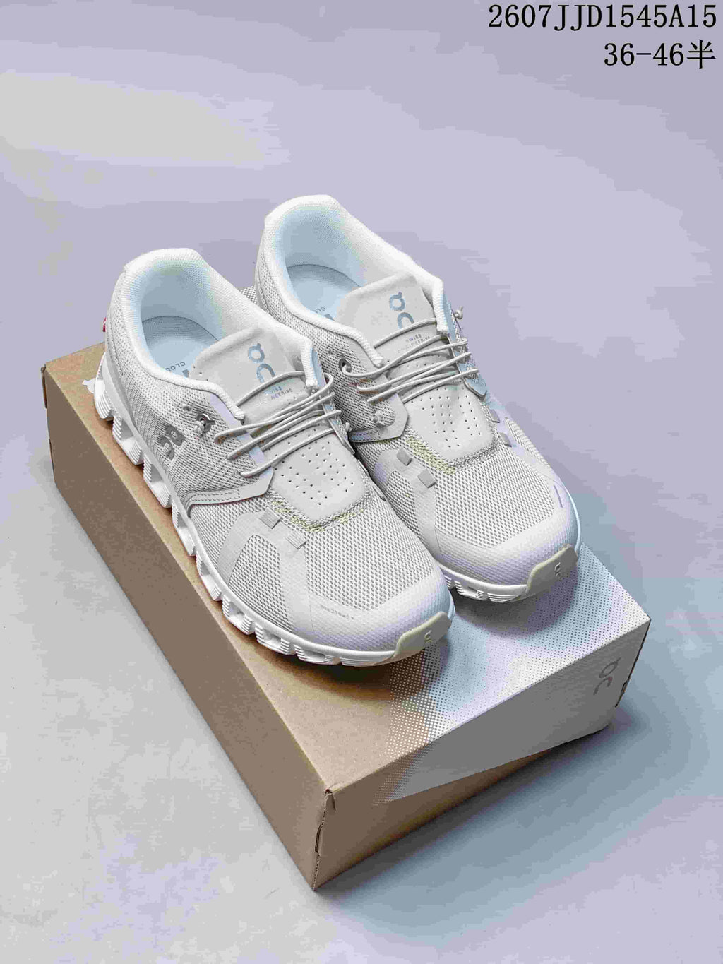 Pair of white and light gray On CloudTilt sneakers displayed on a shoebox, with model code and size range text visible above.