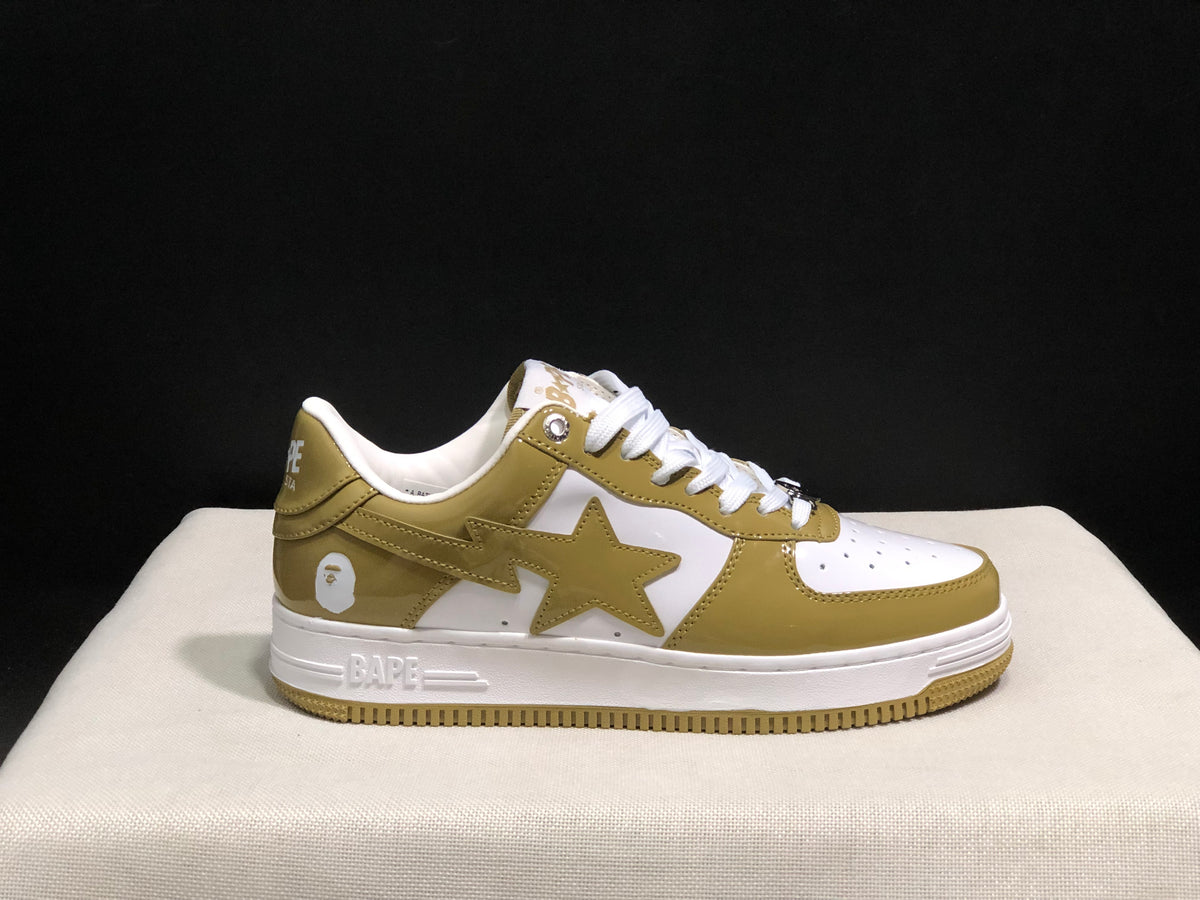 Single side profile of the olive and white sneaker showing the star panel, heel graphic, and BAPE-branded midsole.