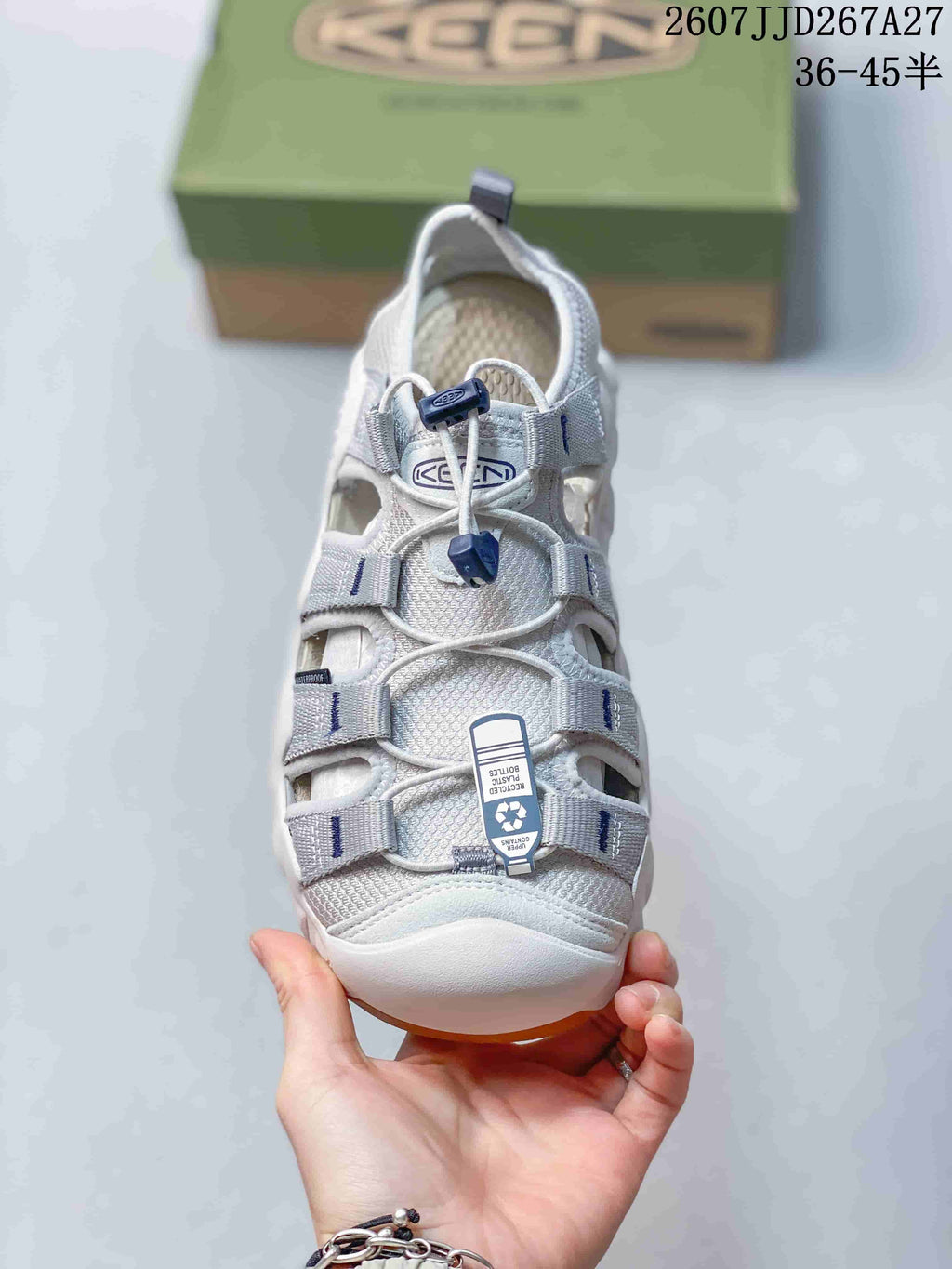 Top view of the KEEN sandal showing the closed toe, multiple upper openings, lace-and-toggle fastening, and attached product tag.
