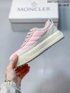 Side view of the pink and white low-top sneaker showing the platform-style sole and stitched panels.