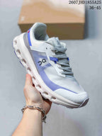 Angled side view of the white and blue On Cloudvista 2 sneaker highlighting the lace-up construction, layered upper, and structured sole.
