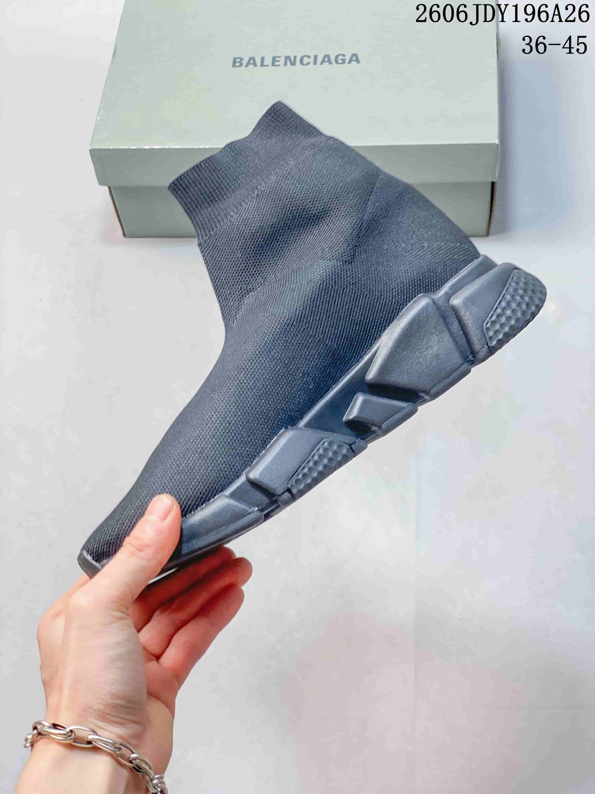 Side profile of a dark gray high-cut sneaker showing the knit upper and segmented outsole construction.