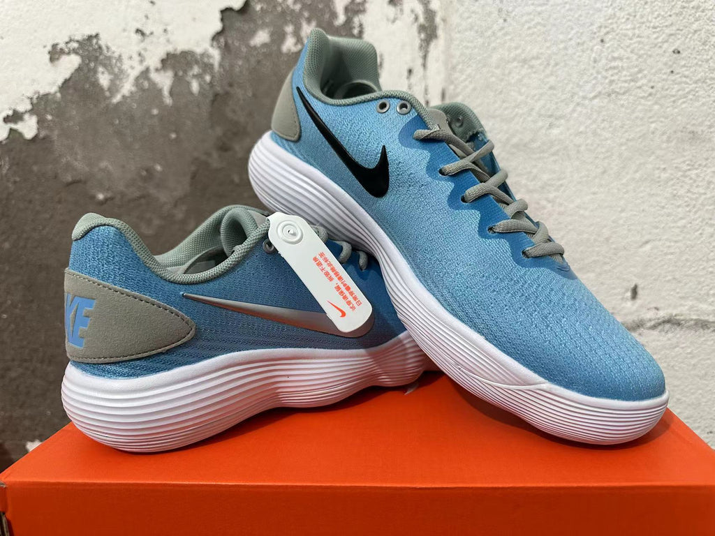 Angled view of blue Nike sneakers showing contrasting heel details and Swoosh logos