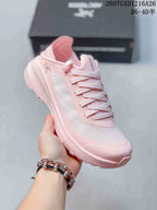Angled side view of the pink Arc'teryx Sylan shoe showing the low-top profile, lace-up design, side panel, and textured outsole.