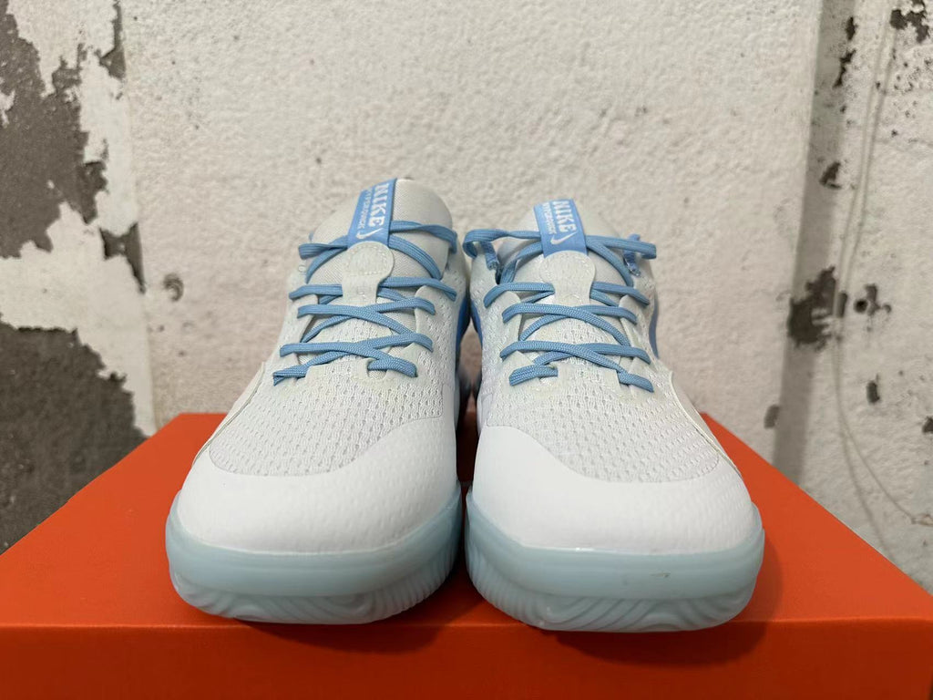 Front view showing blue laces and white uppers on Nike basketball shoes