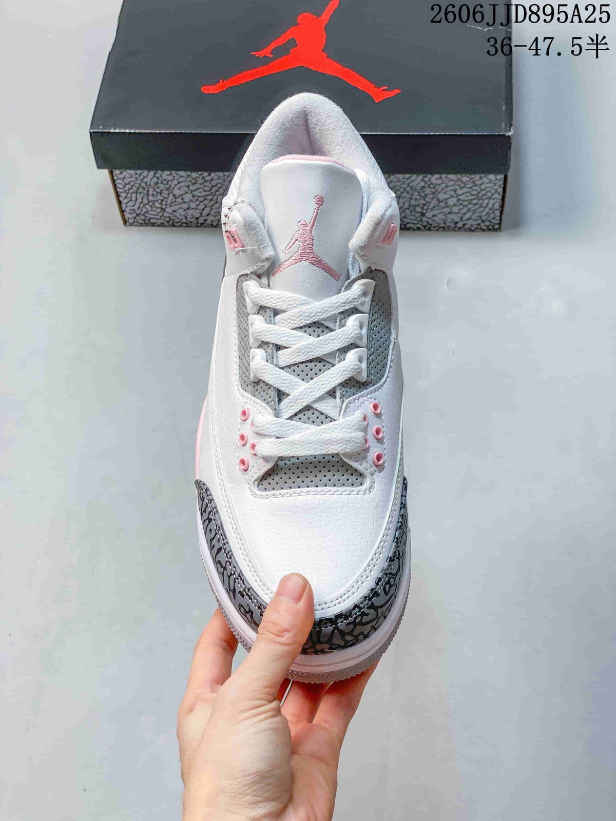Top view showing white laces, gray perforated tongue and side panels, pink eyelet accents, and a pink tongue logo.