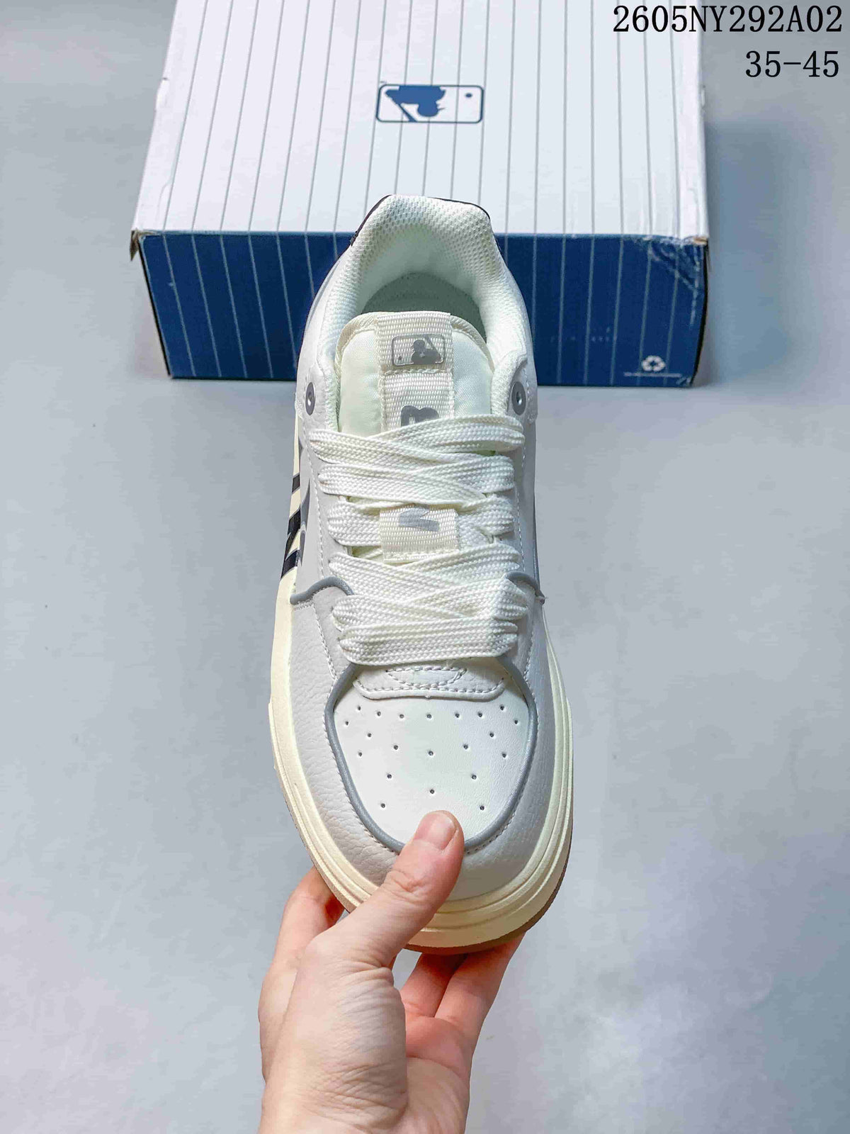 Top view of the sneaker showing white laces, a padded tongue, and a perforated toe panel.
