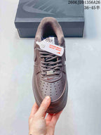Top view of the brown sneaker showing the laces and perforated toe