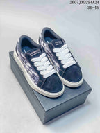 Pair of navy and white NUMERIS low-top sneakers displayed on a shoebox