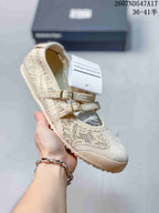 Cream Mary Jane sneaker with a speckled patterned upper, two buckles and a light sole.