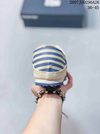 Rear view showing the cream and navy striped heel panel and outsole edge of the sneaker; image text shows model code 2607JDD296A26 and size range 36-45.