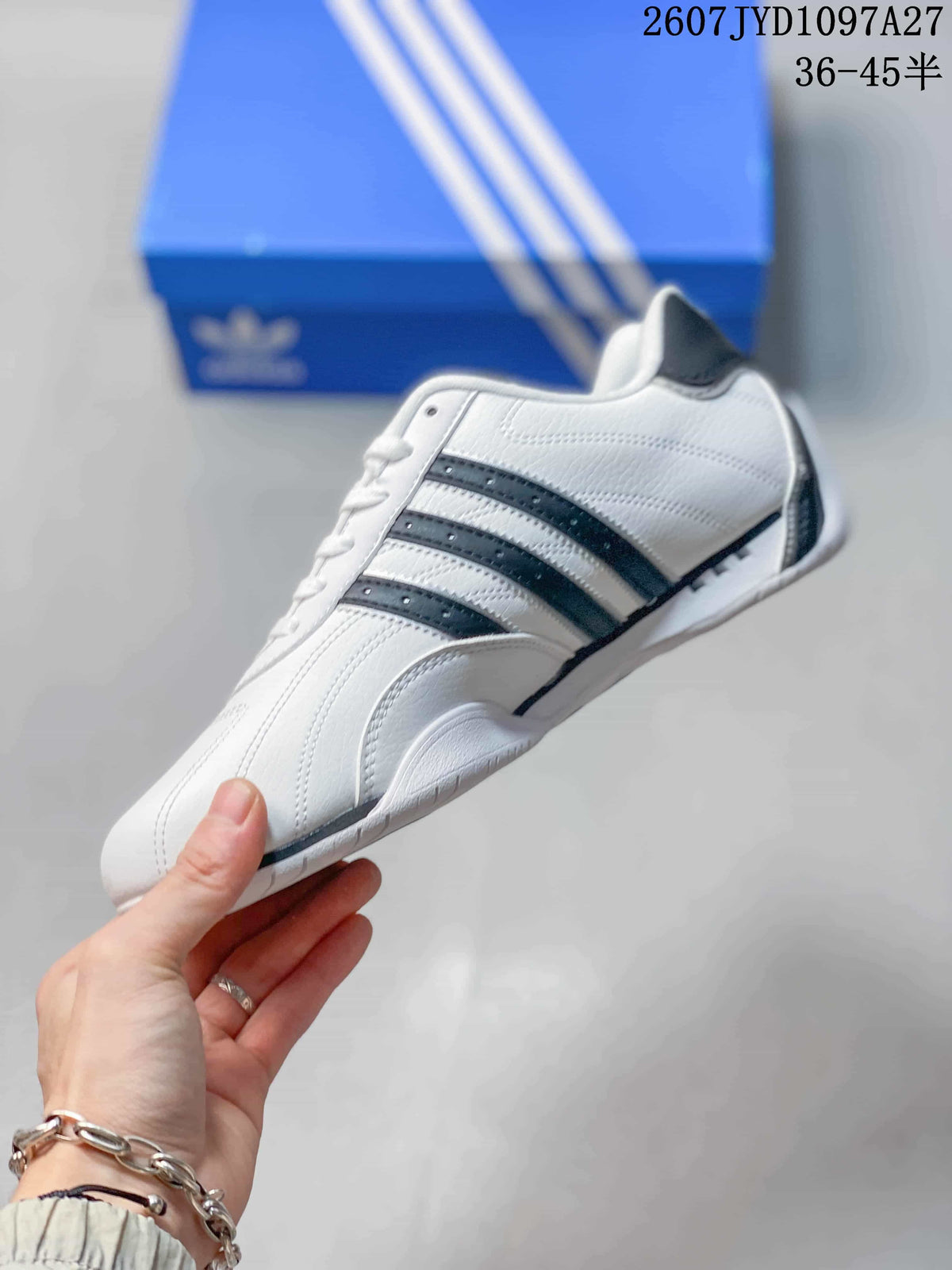 Side profile showing the white upper, dark three stripes, and low-top silhouette.